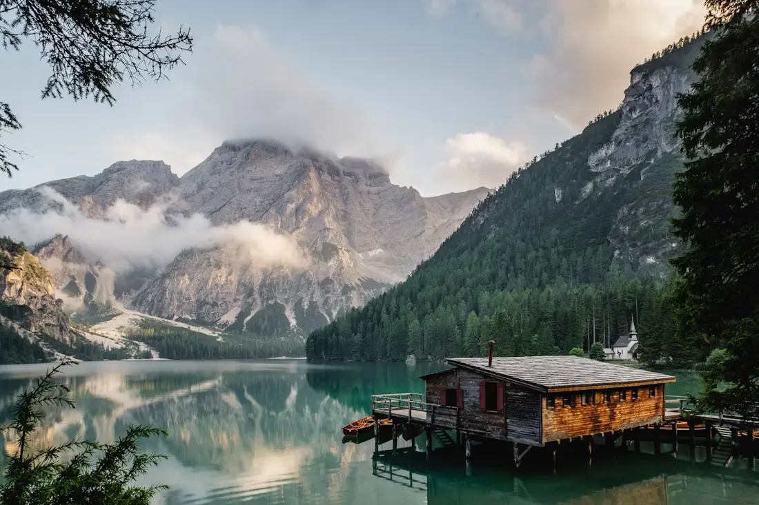 Peaceful Himalayan mountain lake surrounded by forest and mountains